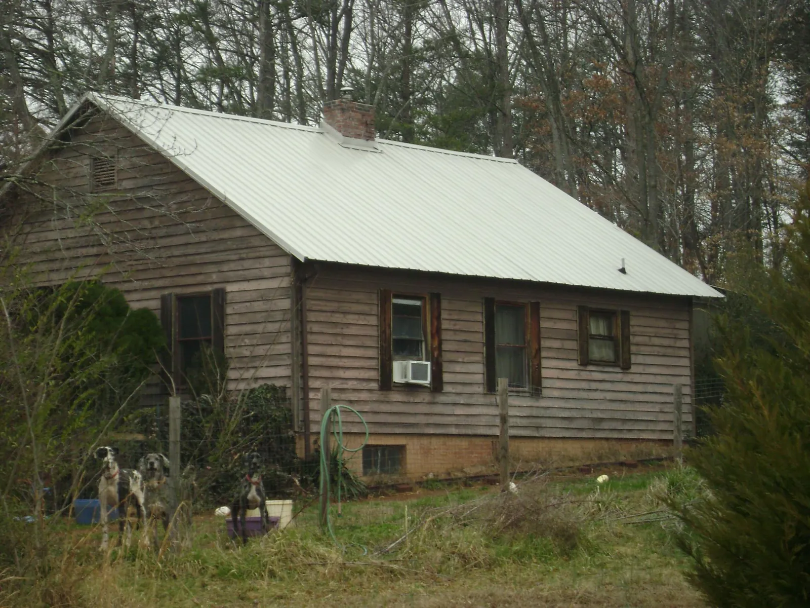 White metal roof on an old wood sided farmhouse, from a Metal Roof Installation job in Reedville